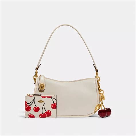 cherry red purse|coach purse with cherry charm.